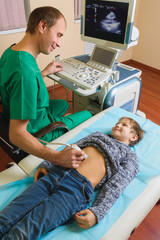 Doctor analyzing boy patient with abdomen ultrasound