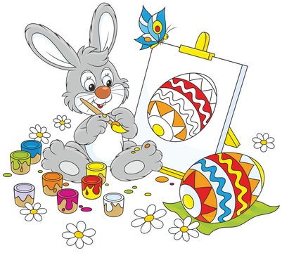 Happy little rabbit drawing a colorful Easter egg on an easel