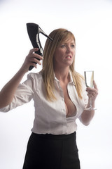 Woman holding a stiletto shoe in extreme anger