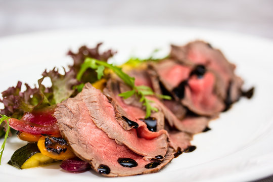 Roast beef is on the plate.