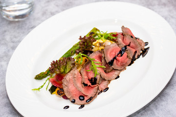 Roast beef is on the plate.