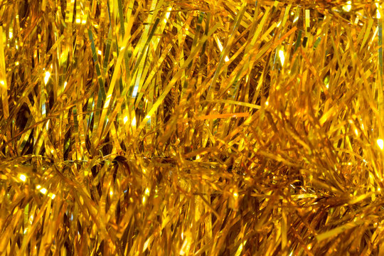 Christmas festive background of shiny Christmas tree tinsel. Selective focus. Blurred macro photo. The concept of Christmas and new year. Free space for text. Copy space