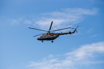 Fototapeta na wymiar Russian military helicopter MI-8 in the blue sky