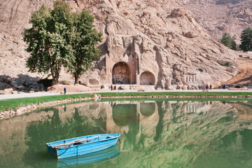 River boat in the lake of oasis near the historical landmarks in Iran
