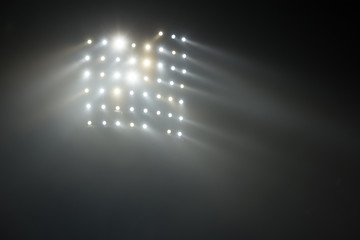 Bright white and yellow Stadium lights with fog