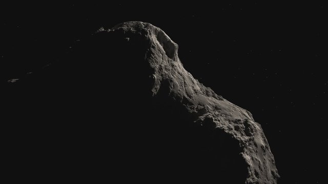 Close-up footage of asteroid turning around in the galaxy. Telescope view.