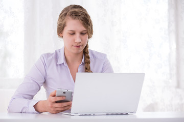 Girl with laptop and cellphone