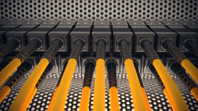 Fiber optic cables plugged into network patch panel in server rack