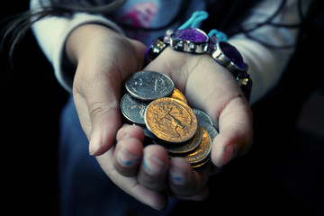 Little girl's hands with coins