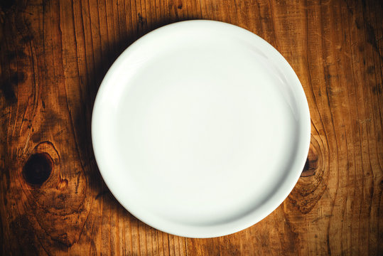 Empty dinner plate on wooden table