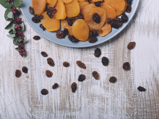 Dried apricots and raisins on a gray plate