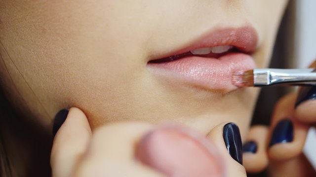 On the lips cause the lipstick with a brush