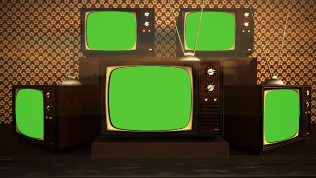 An exhibition of old-fashioned retro color tv sets with tuner antennas.