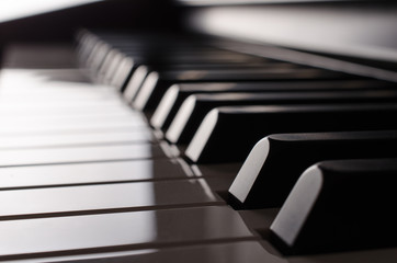 Piano keyboard in the backlight - side view