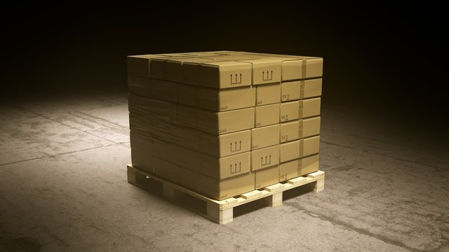 A stack of cardboard boxes on a pallet in the warehouse waiting for a forklift.