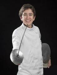 Portrait of a happy foil fencer on black background.