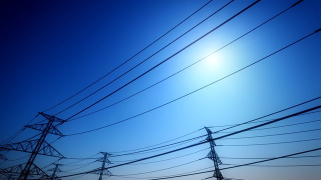 Endless electric powerlines and pylons loopable animation on a navy blue sky. HD