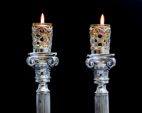 Shabbat candles. Silver candlesticks with olive oil