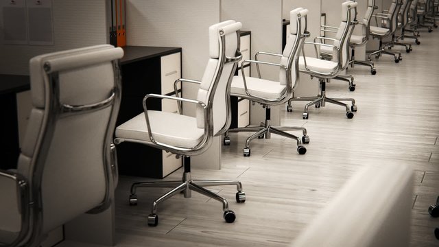 Row of white office chairs with chrome frames in a modern workspace