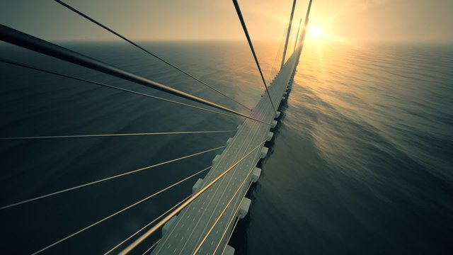 Aerial view of the express highway road running across the long and tall bridge.