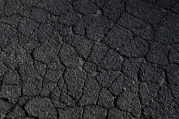 old damaged asphalt road surface with cracks