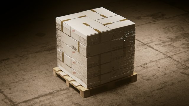 A stack of cardboard boxes on a pallet in the warehouse waiting for a forklift.