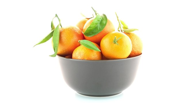 Tangerines on ceramic brown  bowl  isolated on white background