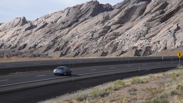 A yellow truck passing on I-70 in Southern Utah
