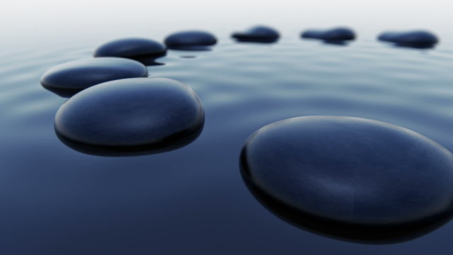Animation of dark smooth pebbles outstanding over the water level. Loopable. HD