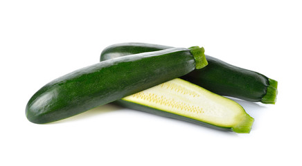 whole and half cut fresh Zucchini on white background