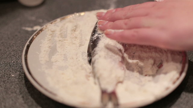 Breaded haddock being fried in a pan.