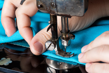 Old vintage hand sewing machine. Sewing clothes at home