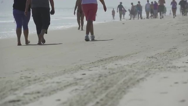 People enjoy a sandy beach on a sunny day