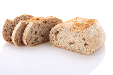 loaf and slices of bread on a white background