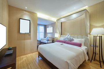 interior of modern bedroom with comfortable bed and sofa