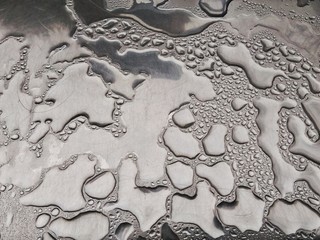 Closeup of water drops on metallic surface