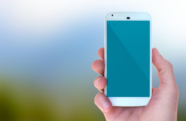 Modern mobile smart phone in male hand with natural bokeh style