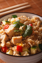 Japanese fried rice Tyahan with chicken in a bowl macro. Vertical 
