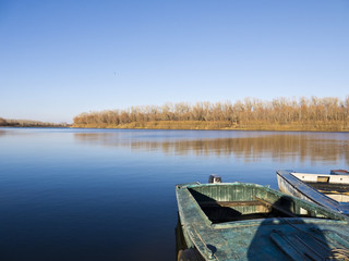Fototapeta premium Old boat on the shore of the autumn river 