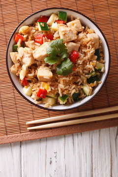 Tyahan - fried rice with chicken and vegetables. vertical top view
