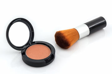 Closeup of face powder and makeup brush.