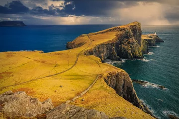 Papier Peint photo Lavable Île Dramatic cloudy and rainy sky over Neist Point and its lighthouse on Isle of Skye, Scotland, UK