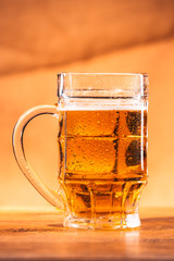 glass bright beer mug on a blurred background