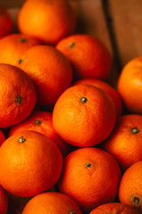 many fresh tangerines on a wooden background