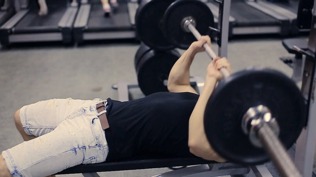  man doing bench press workout in gym