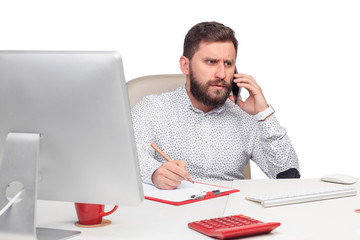 Portrait of businessman talking on mobile phone in office