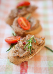 Chicken liver pate on bread with cherry tomatoes  