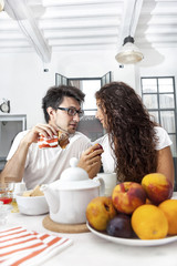 teenage couple has breakfast at home