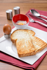 breakfast set in Malaysia consisting of toast bread and half-boiled egg