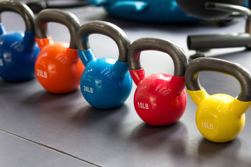 colorful kettlebells lining on table